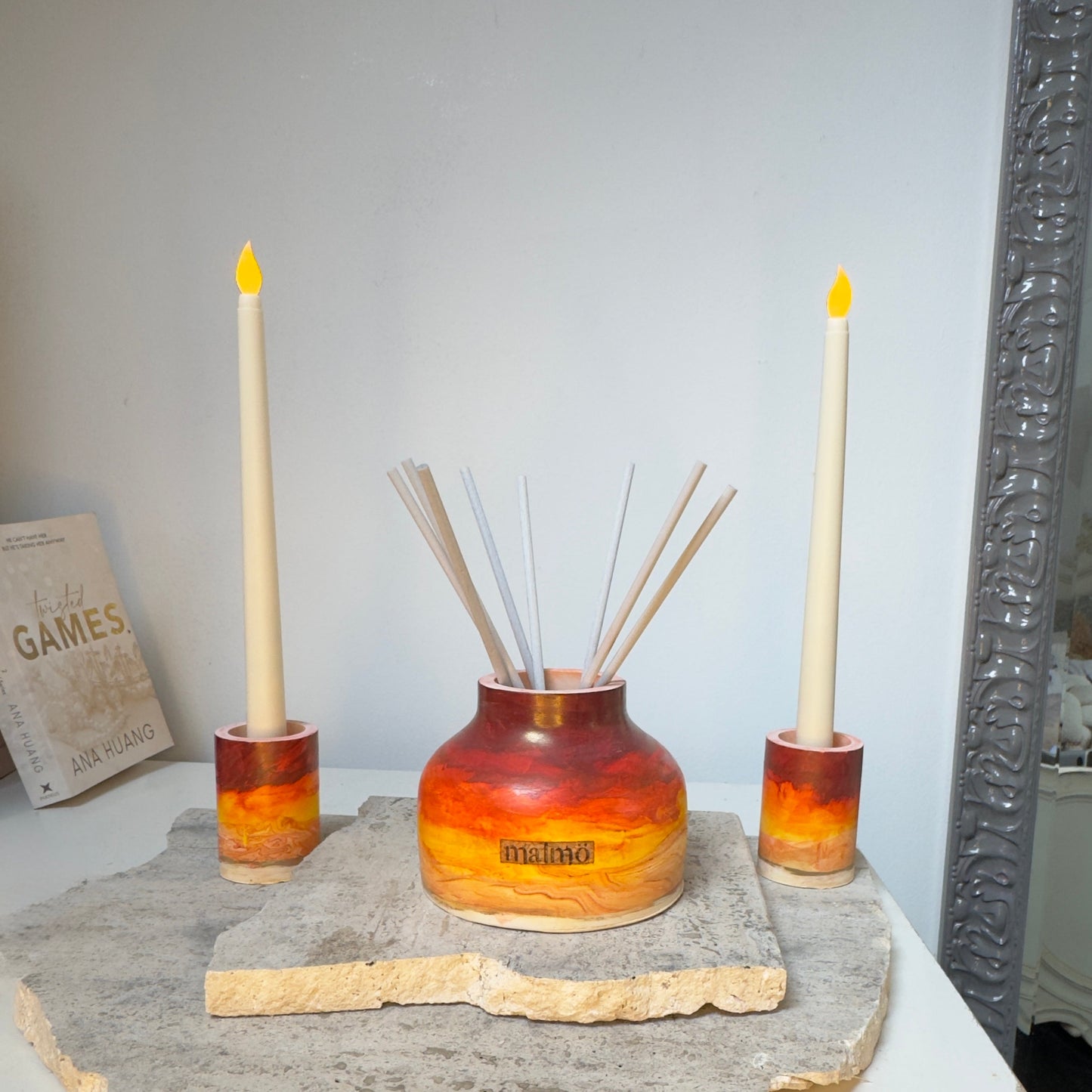 Handmade candlestick holders in warm sun tone, battery-operated and flame-free, ideal for weddings and outdoor settings.