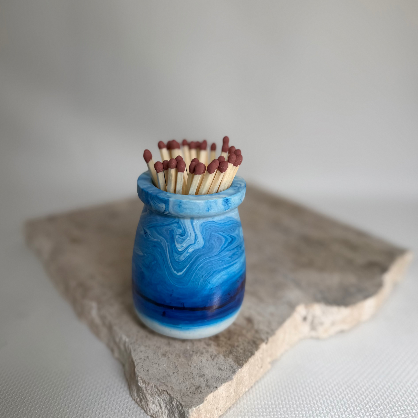 Malmo Home Sky match pot, pale blue stone-effect ceramic with long safety matches, top view