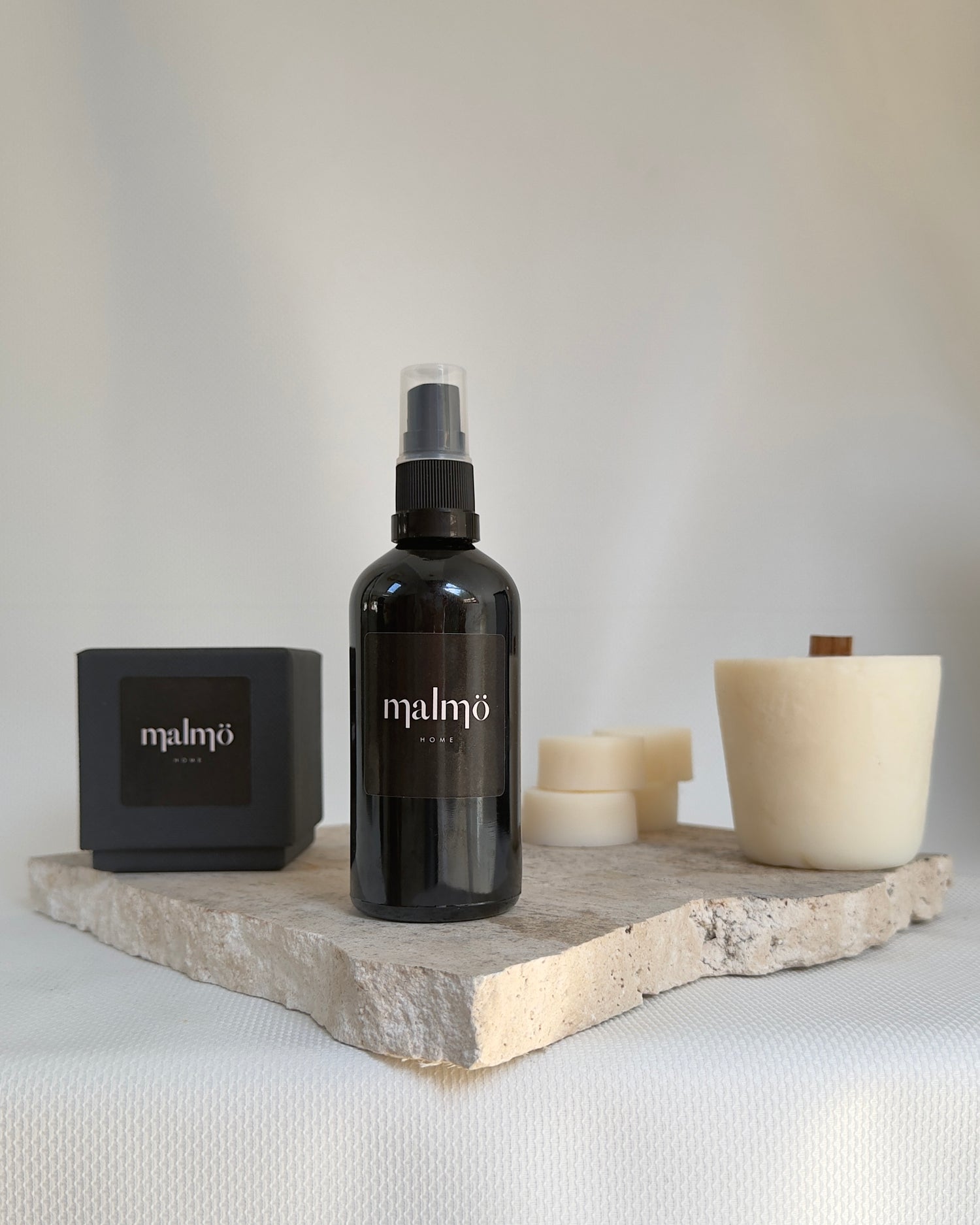 Malmo Home Malmo Moments subscription box, soy wax refill, room mist and wax melts on marble surface
