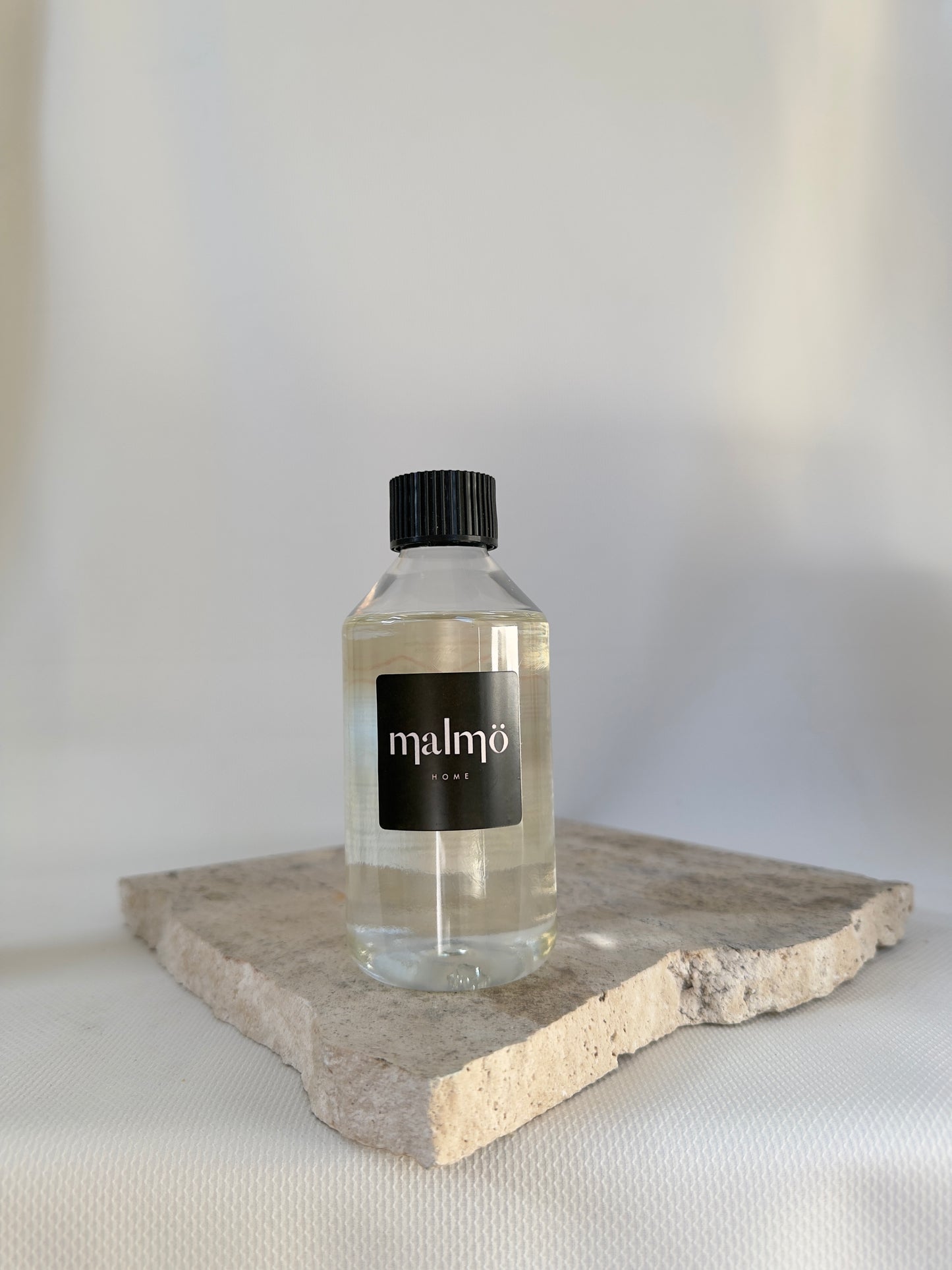 Malmo Home diffuser oil refill, 250ml fragrance oil in recyclable bottle, neutral background
