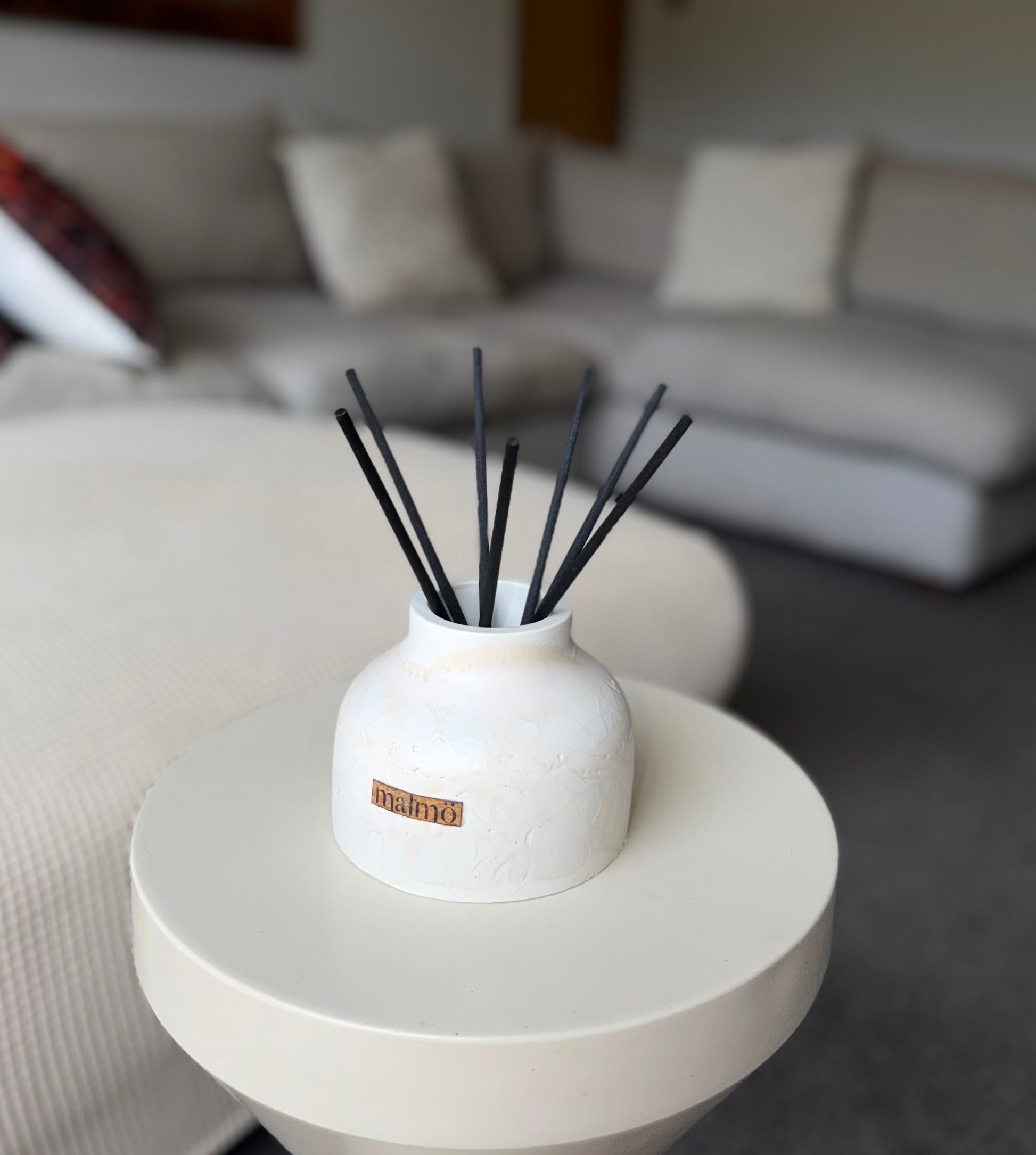 Malmo Home Natural Drom diffuser, lifestyle shot on wooden shelf, warm light
