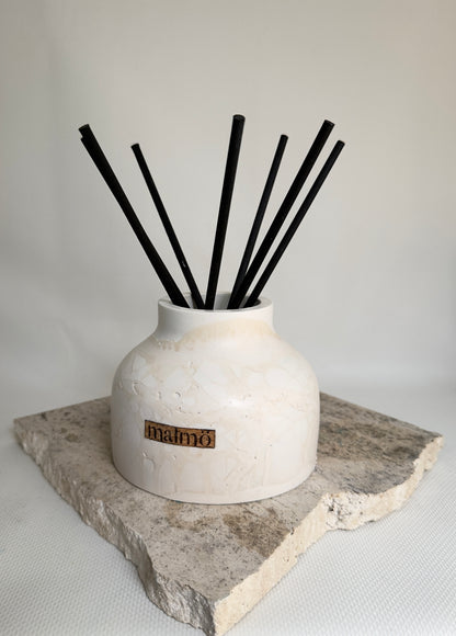 Malmo Home Natural Drom reed diffuser, stone-effect ceramic vessel with rattan reeds, front view
