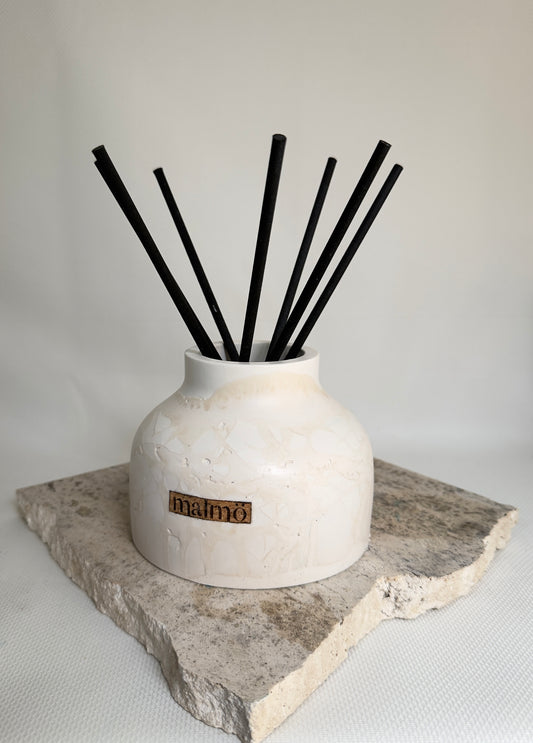 Malmo Home Natural Drom reed diffuser, stone-effect ceramic vessel with rattan reeds, front view
