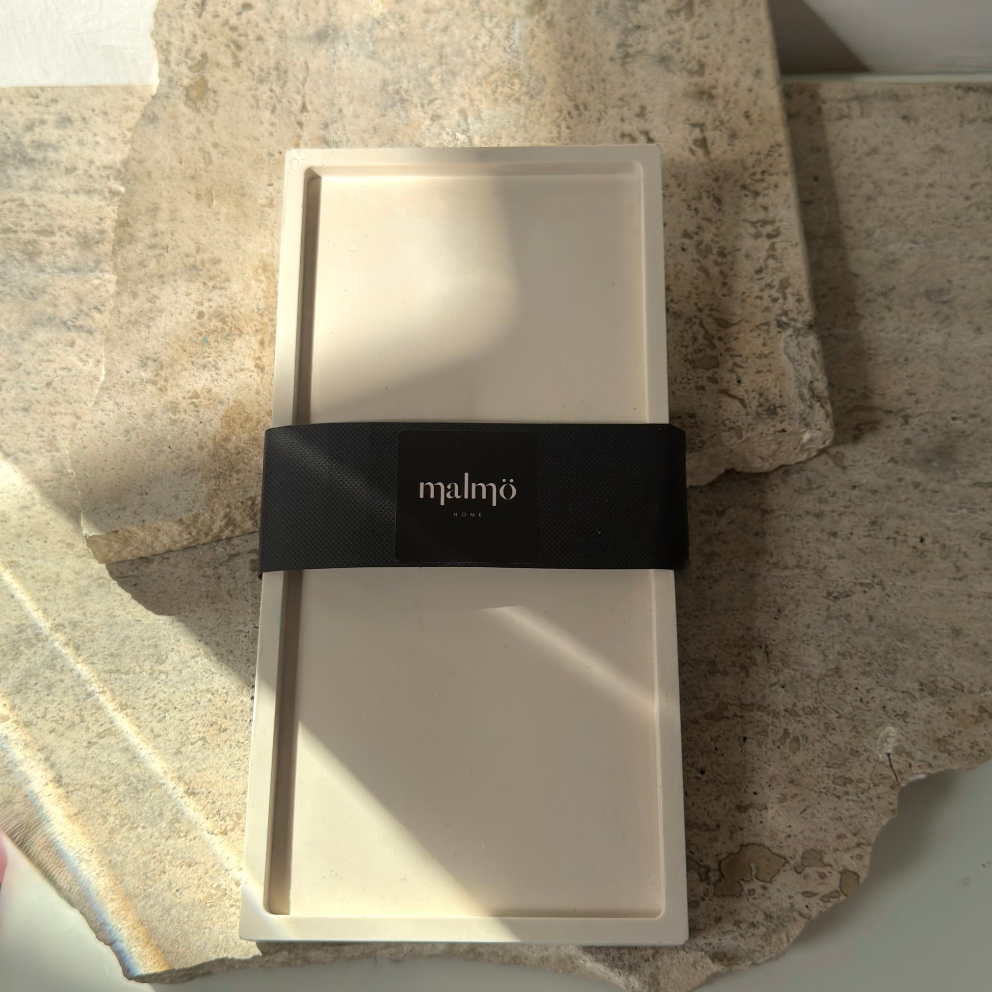 Malmo Home Poise Rectangle raised decorative plinth with Malmo Home band, top-down view on a stone surface