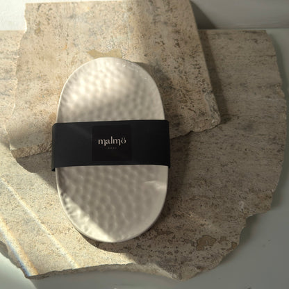 Malmo Home Poise Oval plinth with Malmo Home band, top-down view on a stone surface