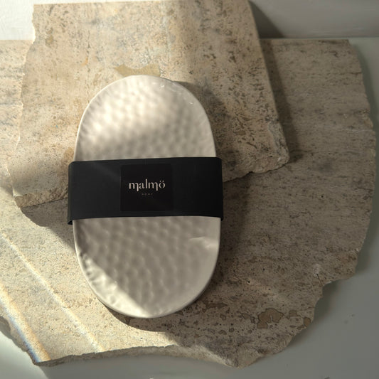 Malmo Home Poise Oval plinth with Malmo Home band, top-down view on a stone surface