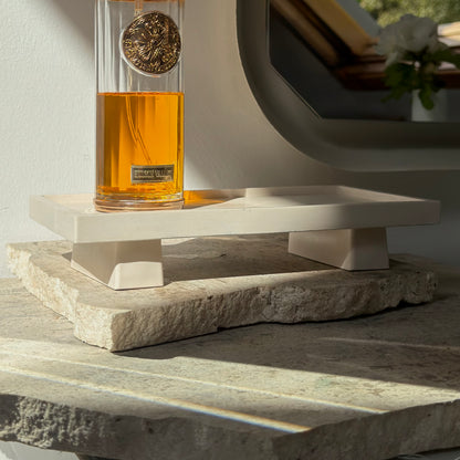 Malmo Home Poise Rectangle plinth styled with a perfume bottle on a stone surface in natural light